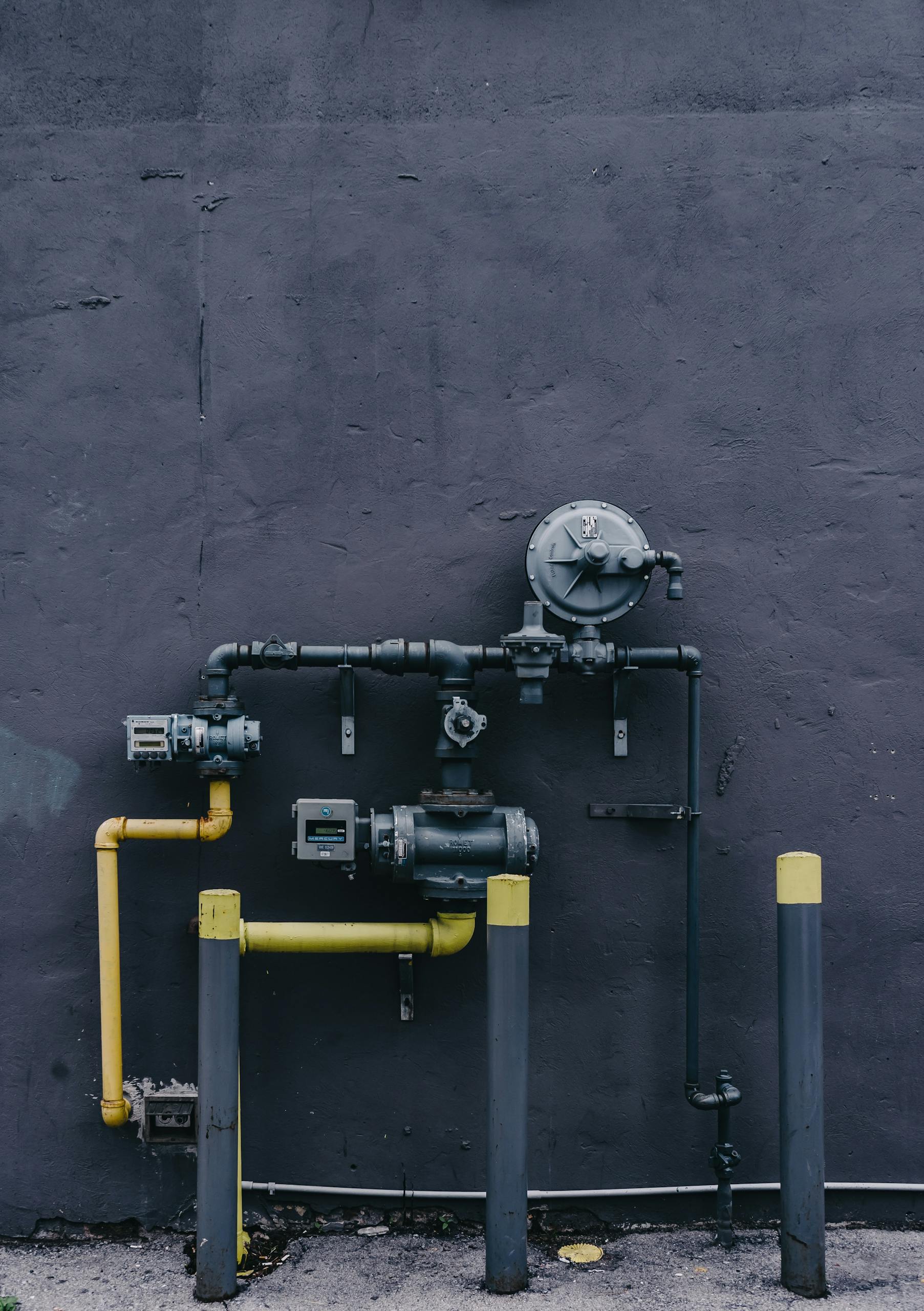 Water supply pipes and shutoff valves feeding a washing machine in an Albany basement